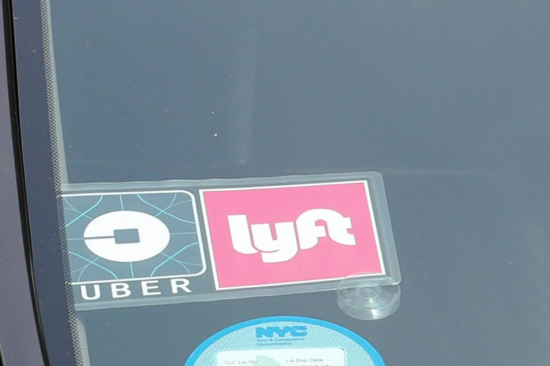 The Uber and Lyft logos are seen on a vehicle in Manhattan, New York on July 27, 2018.